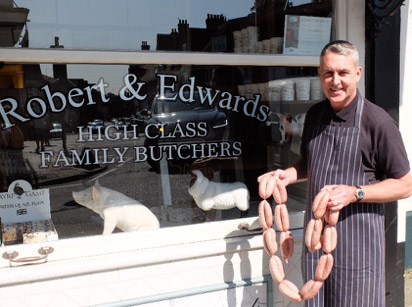 Photo of Robert Hewitt local butcher with his sausages!