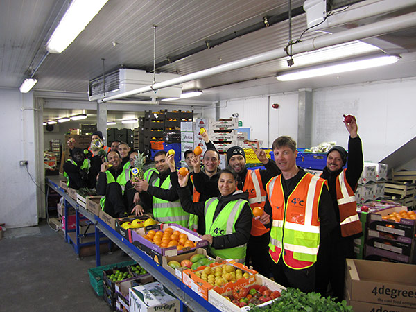 The team at 4 Degrees C - smiling and holding produce samples